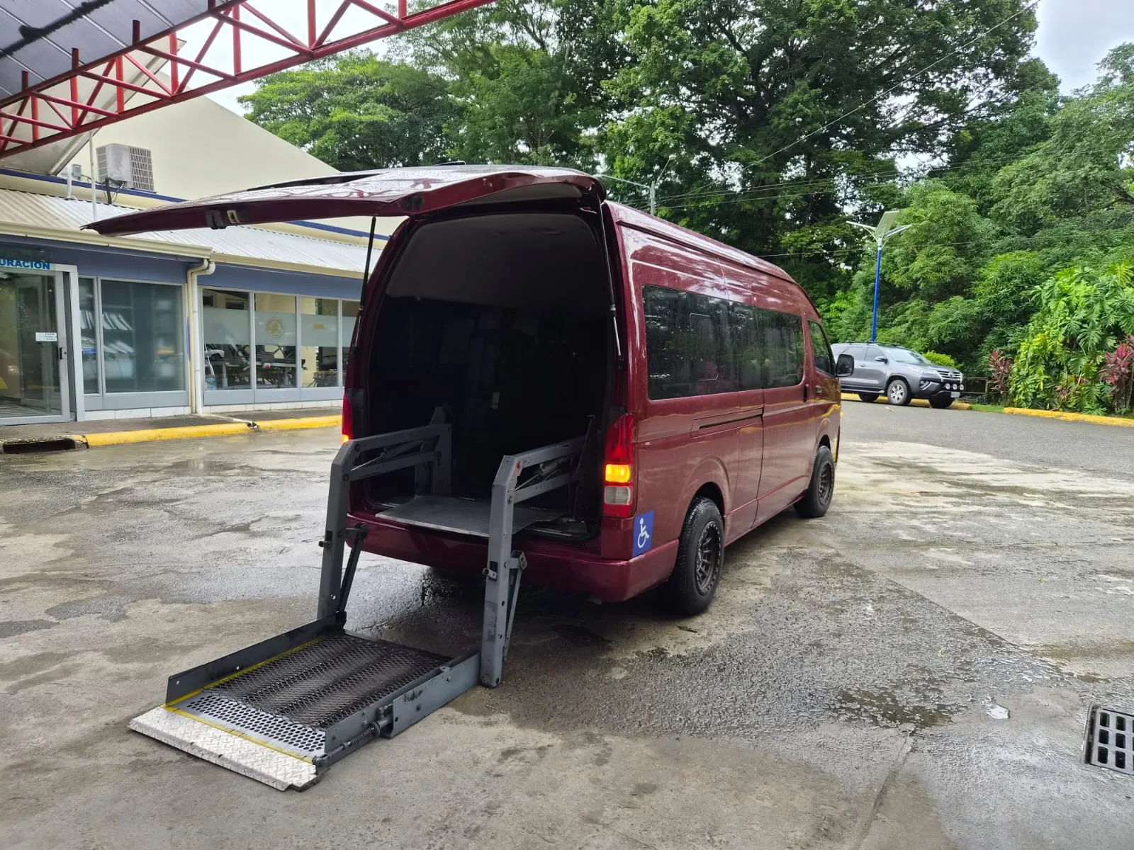 Hydraulic wheelchair platform lowered behind the accessible van
