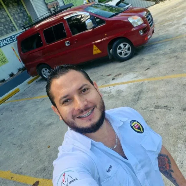 Keiner Quintavalle beside his red taxi in Quepos